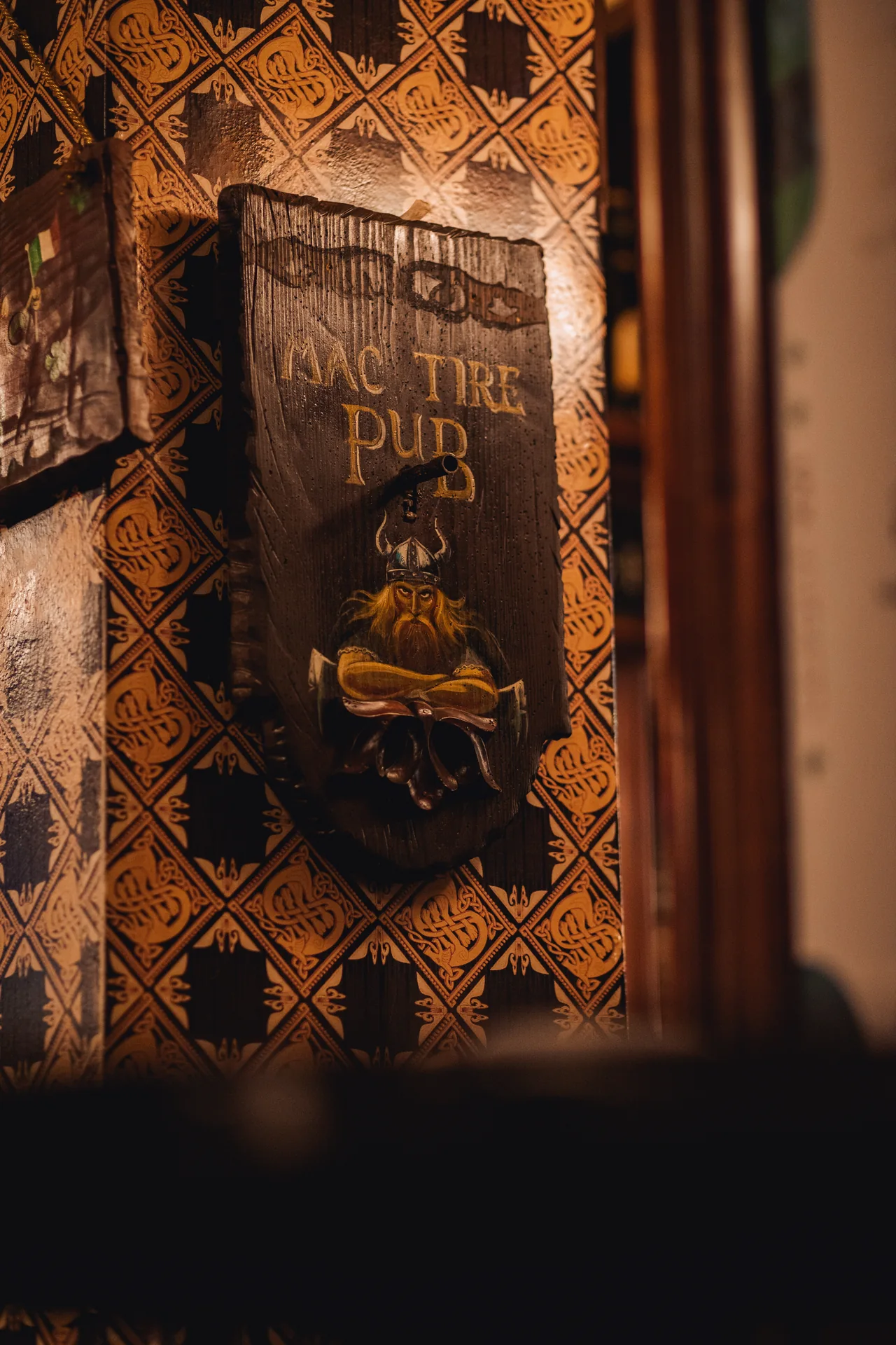 Mac Tire Pub sign on the wooden panelling