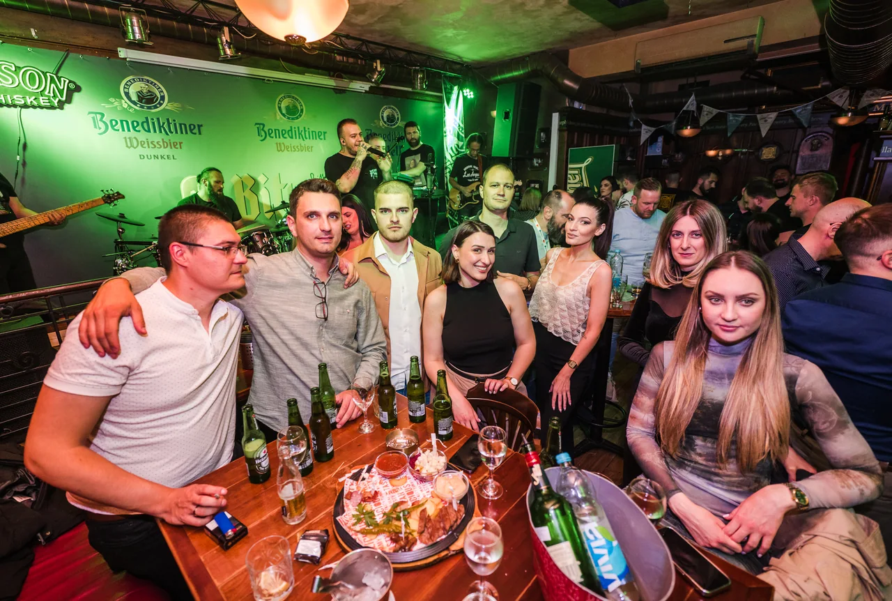 Društvo okupljeno oko stola u pubu