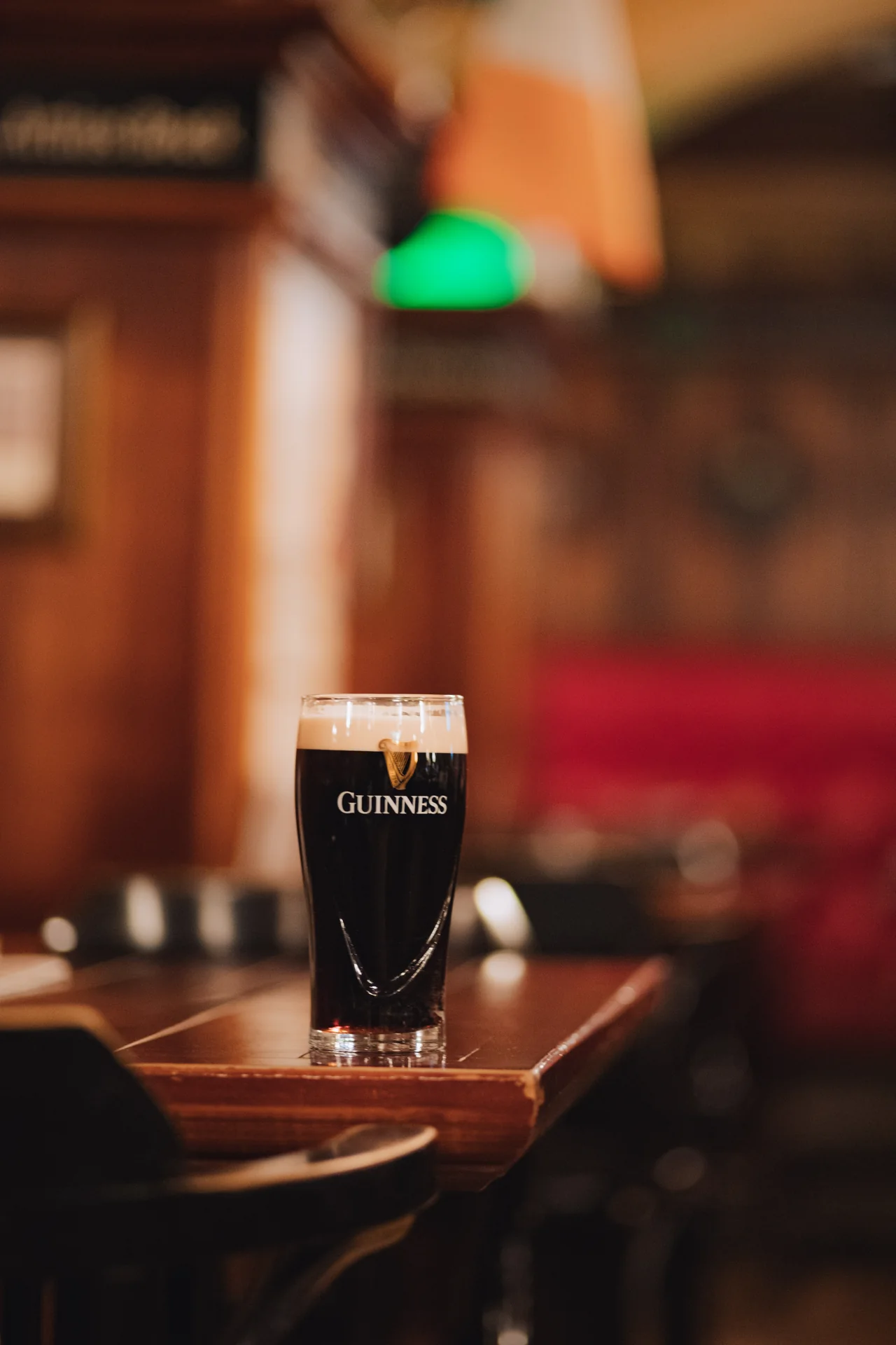 A glass of Guinness in Mac Tire’s warm wooden interior.