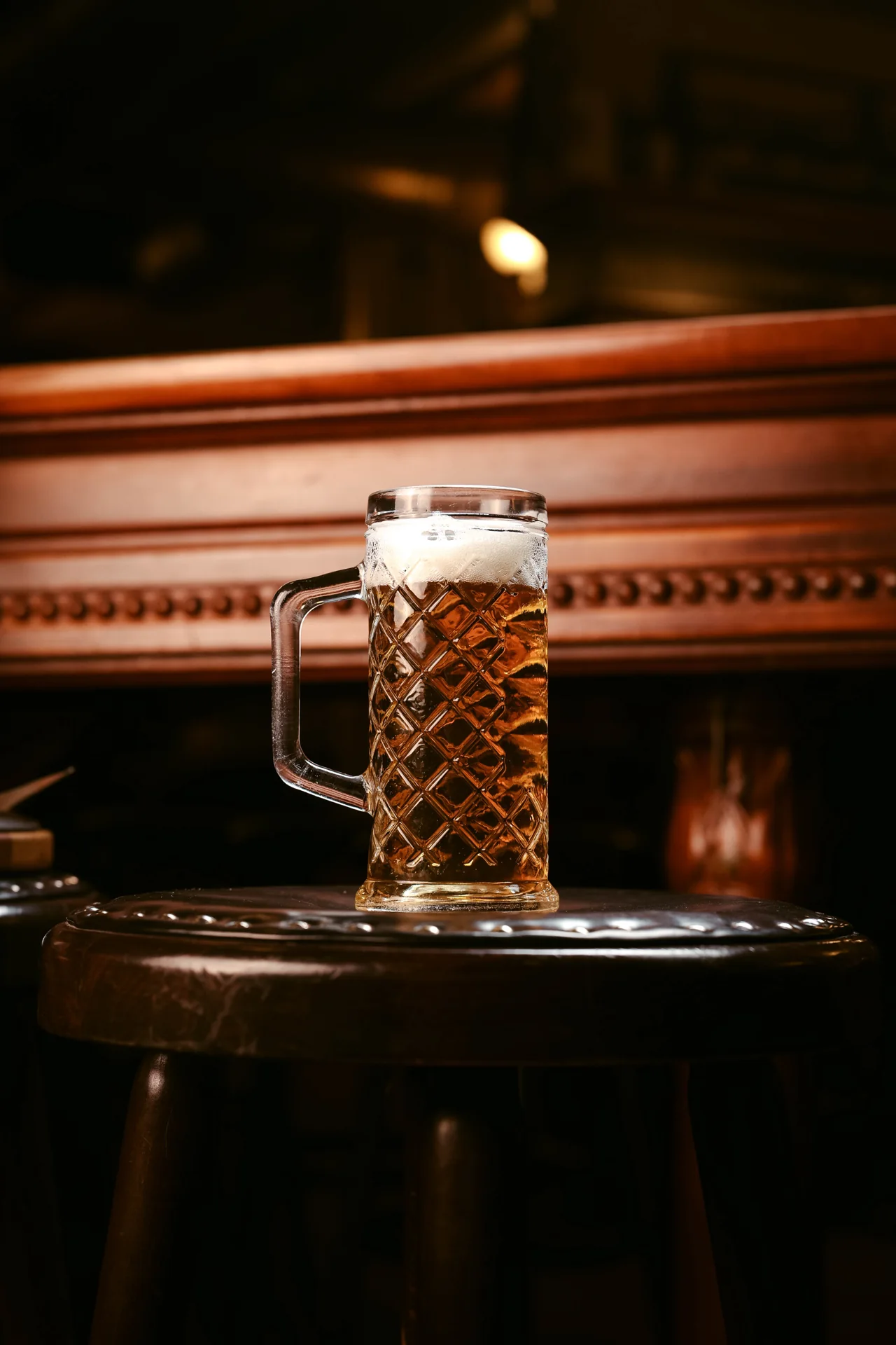 A beer mug on a wooden table at Mac Tire Pub.
